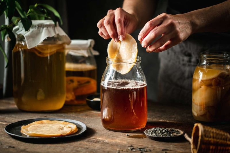 Homemade kombucha fermentation with SCOBY in a glass jar