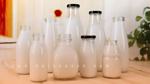 Glass milk bottles in several sizes=