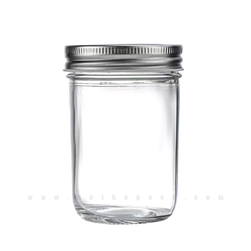Clear cylindrical glass jar with a silver screw lid