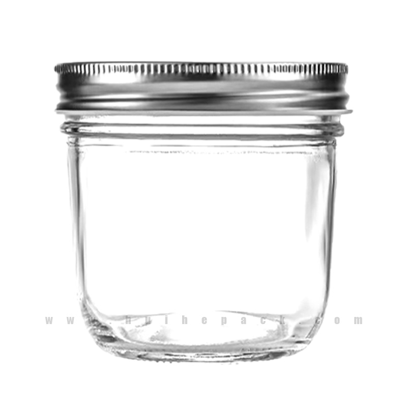 Low-profile clear glass jar with a gold-colored lid