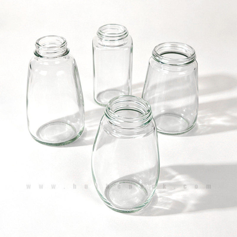 Clear glass spice storage jars in a rounded profile