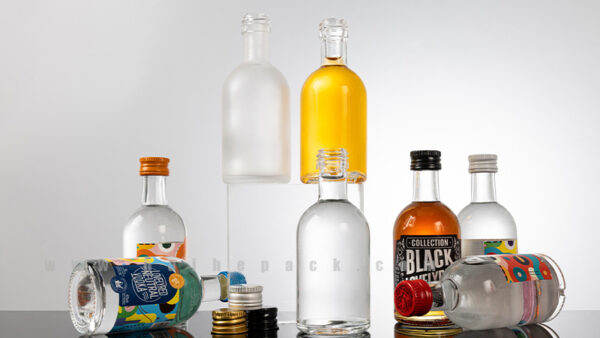 Assorted miniature glass spirit bottles with different closure and label styles